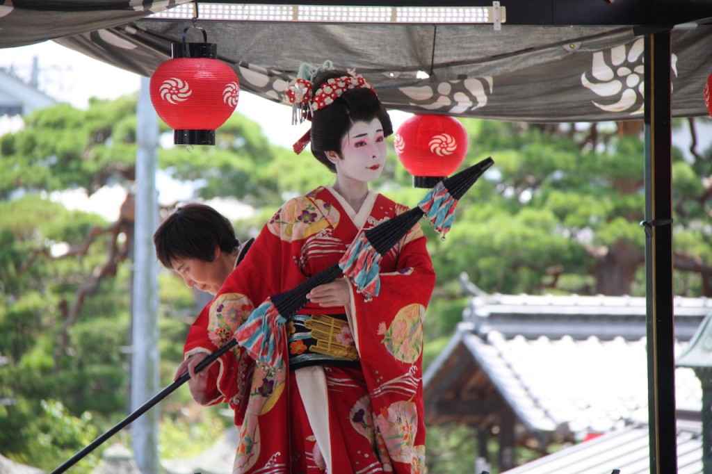 A geisha poses during the Gion Festival in Nagano City in July.