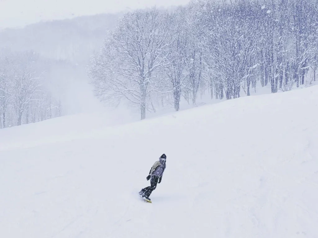 Snowy weather for a snowboarder at Myoko Ski Resort in Nagano.