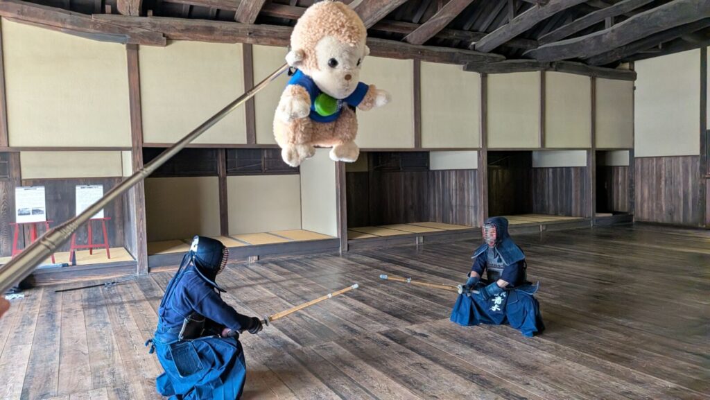 The Snow Monkey Resorts mascot oversees Kendo instruction for guests at the Matsushiro Bunbu Gakko.