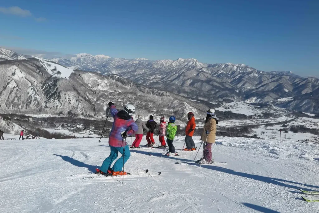 A group of skiers prepare to tackle a slope in Hakuba, Japan.