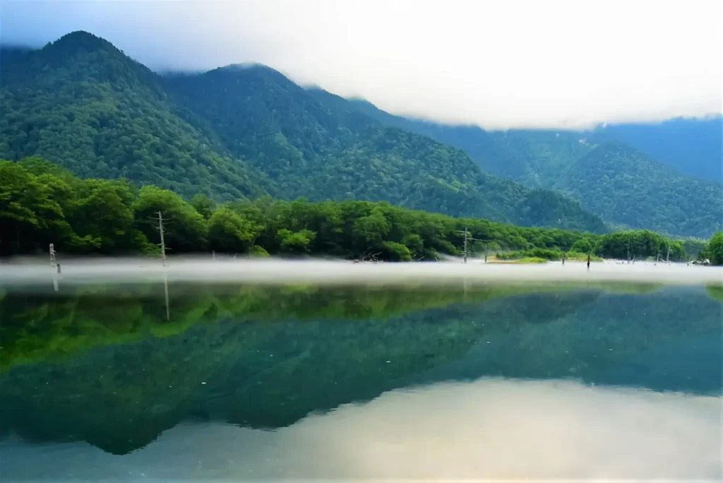 A reflection of the mountains surrounding Taisho pond in Kamikochi.