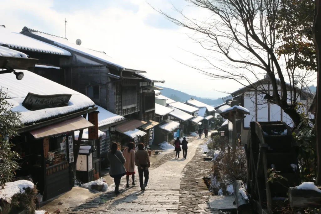 Magome-juku on the Nakasendo trail in March with snow on the roofs of houses.