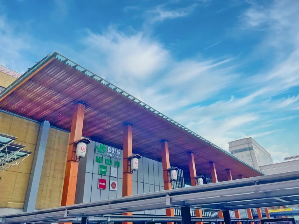 A view of the clear sky from the ground floor outside of Nagano Station.