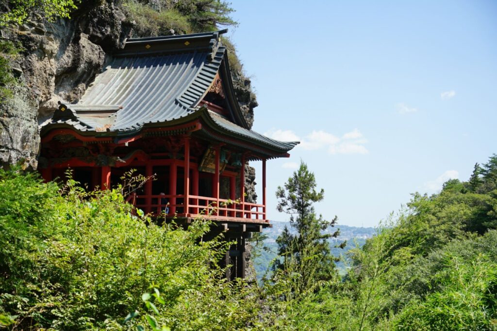 A stunning view of the cliffside featuring Shakuson-ji Temple in Nagano, Japan.